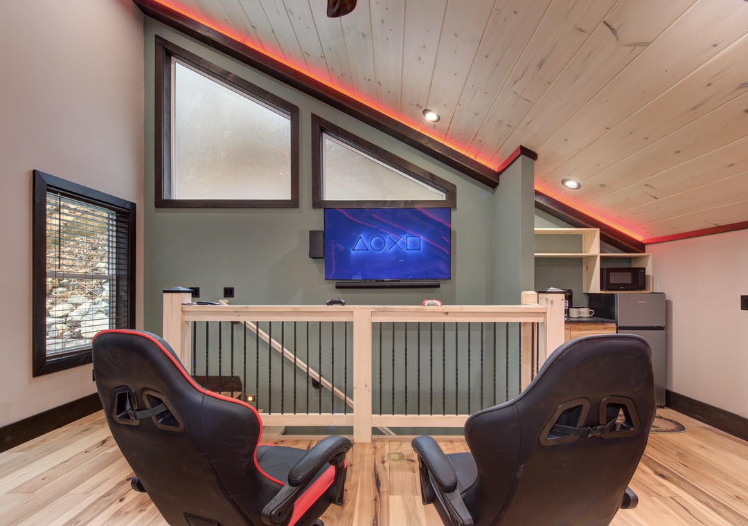 Challenge friends to gaming marathons in your dedicated game room, complete with racing chairs and atmospheric LED lighting.