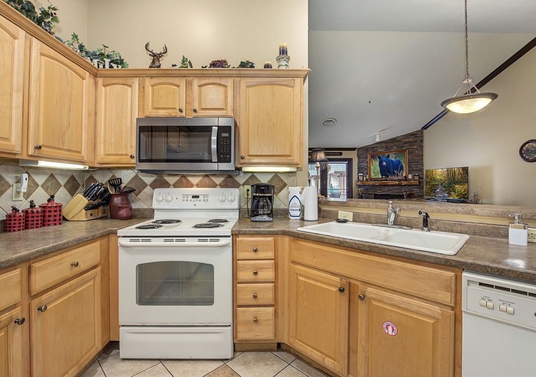 Your fully equipped kitchen awaits with warm wood cabinets, granite countertops, and all the appliances you need to create memorable meals during your stay.