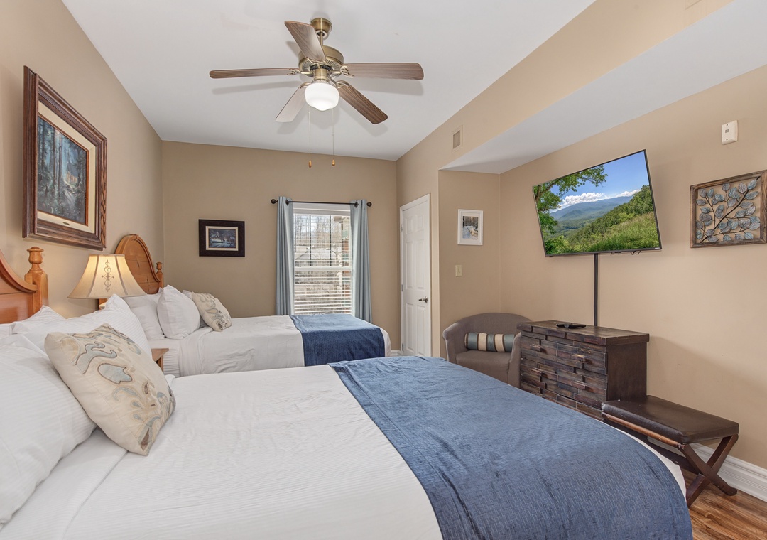 Unwind in your cozy twin bedroom with plush linens, mountain views on TV, and peaceful decor.
