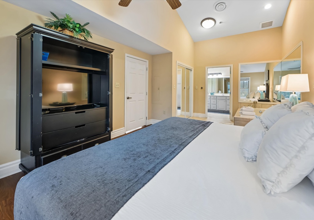 Unwind in your spacious master suite with plush bedding, entertainment center, and luxurious ensuite bathroom for ultimate relaxation.