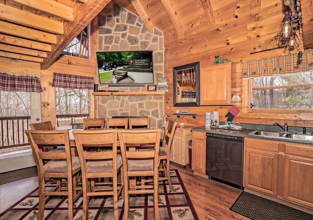 Your cozy cabin kitchen features rustic wood warmth, stone fireplace charm, and full cooking amenities for memorable mountain meals together.