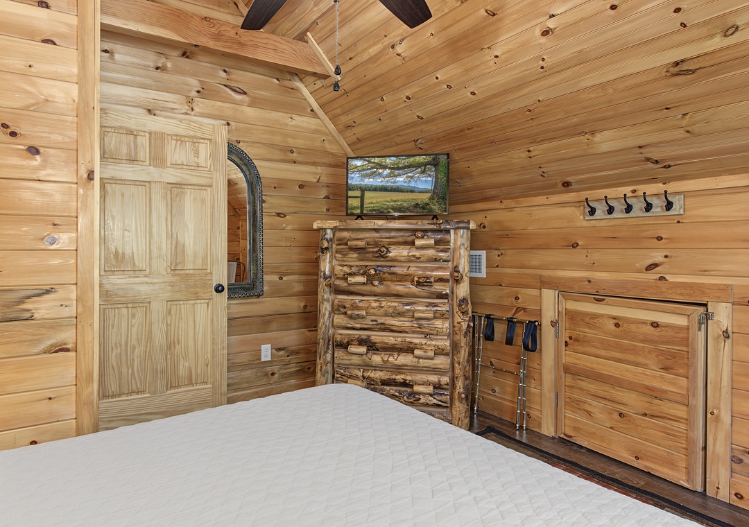 Natural wood wraps your bedroom in rustic warmth, with handcrafted log furniture and vaulted ceilings that create a cozy, cabin-style retreat perfect for restful nights.
