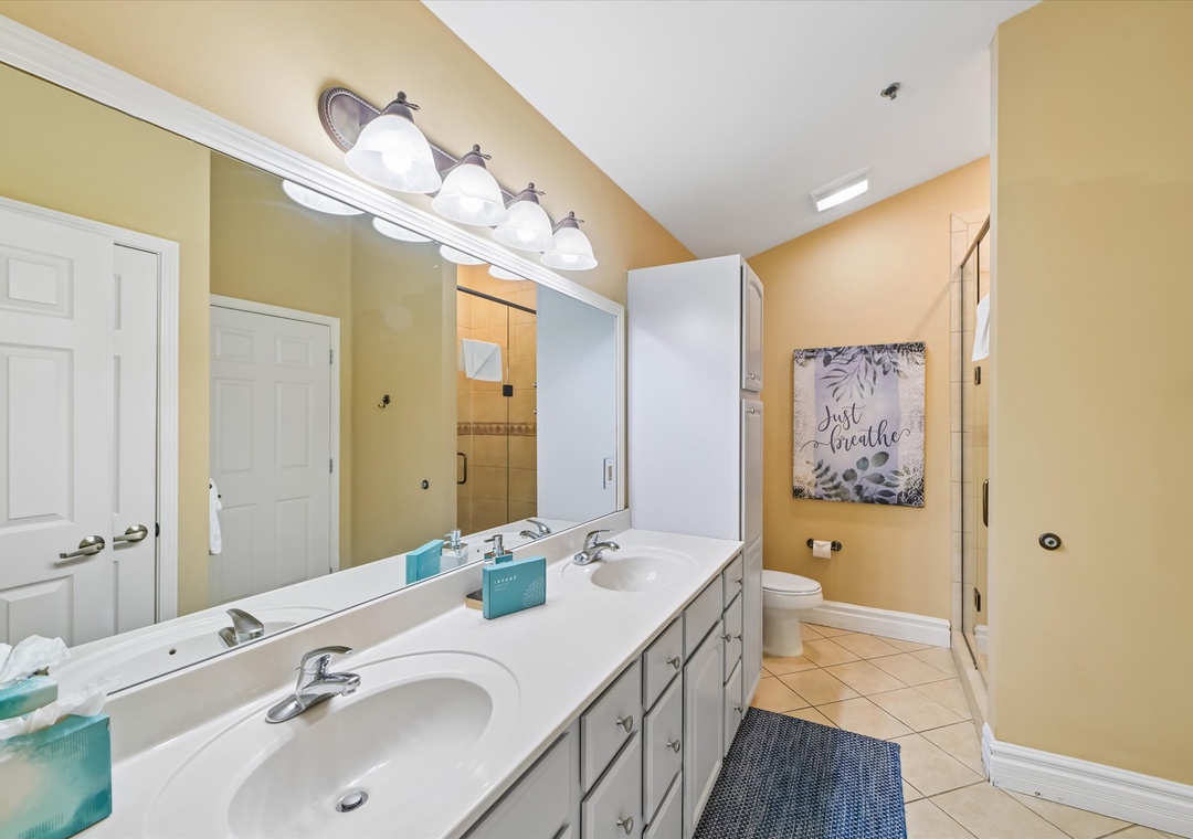Freshen up in your spacious master bathroom featuring dual sinks, elegant lighting, and warm touches that make mornings feel effortless.