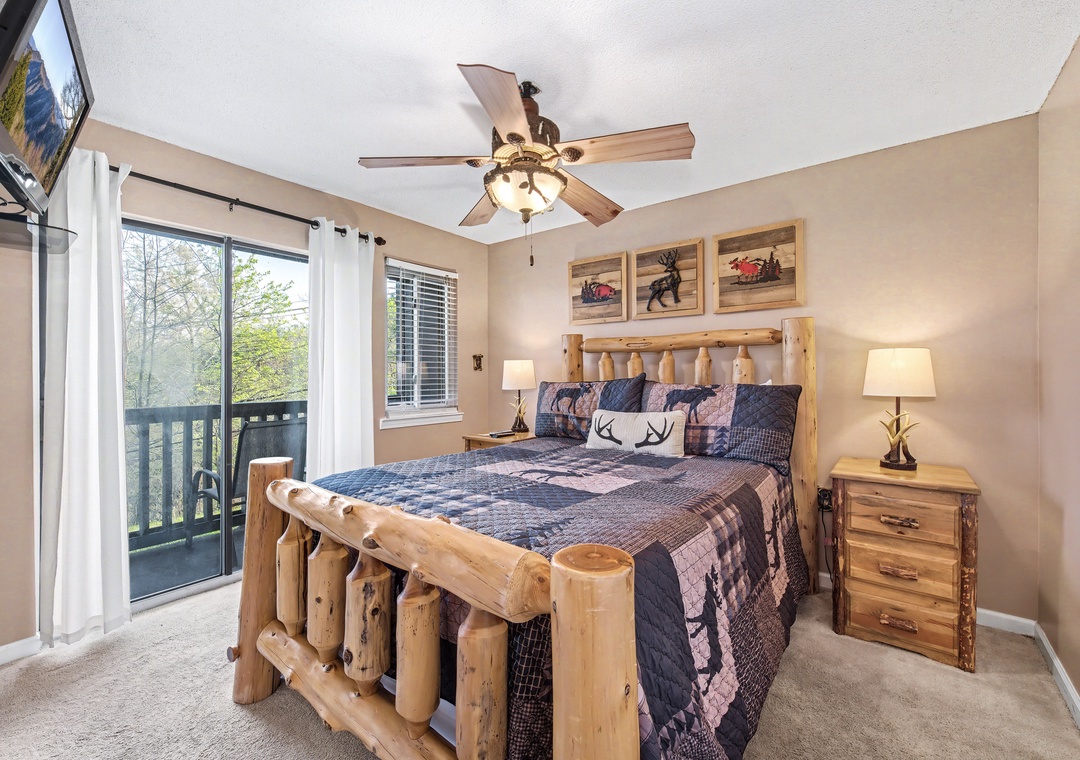 Drift off in your rustic log bed while the ceiling fan keeps you comfortable. Natural light and forest views create a peaceful mountain retreat.