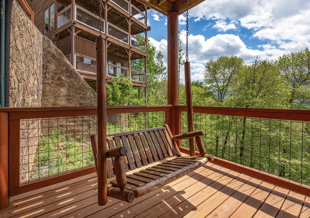 Relax on your private deck swing with stunning forest views stretching beyond the railings.