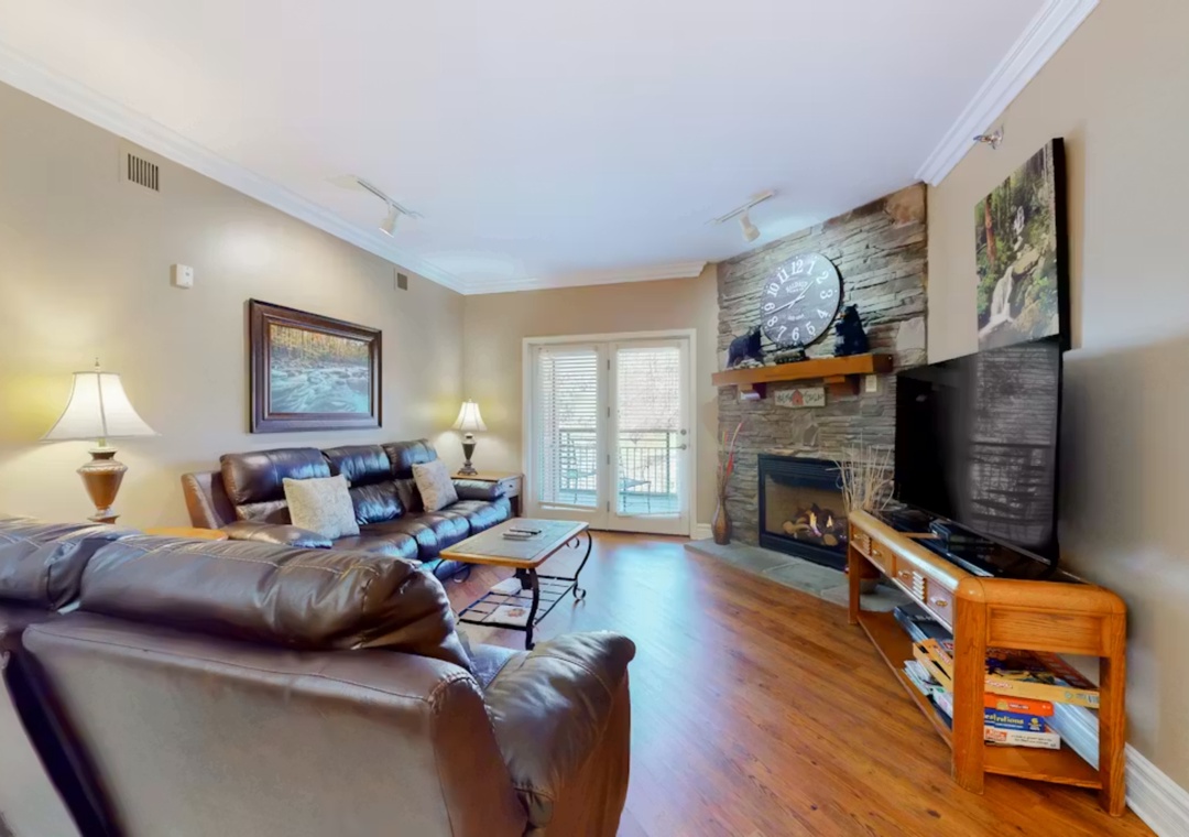 Sink into plush leather seating by the stone fireplace, where warmth and comfort create your perfect retreat.