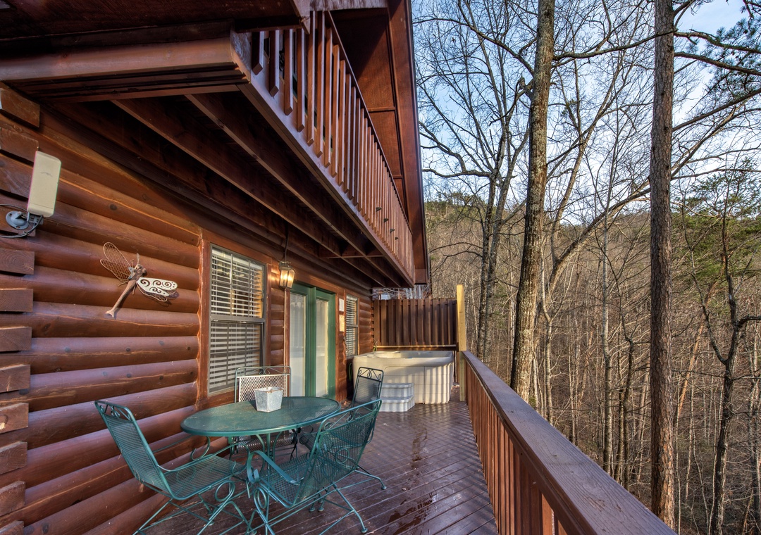 Unwind on your private deck with forest views, outdoor dining space, and relaxing hot tub nestled among towering trees.