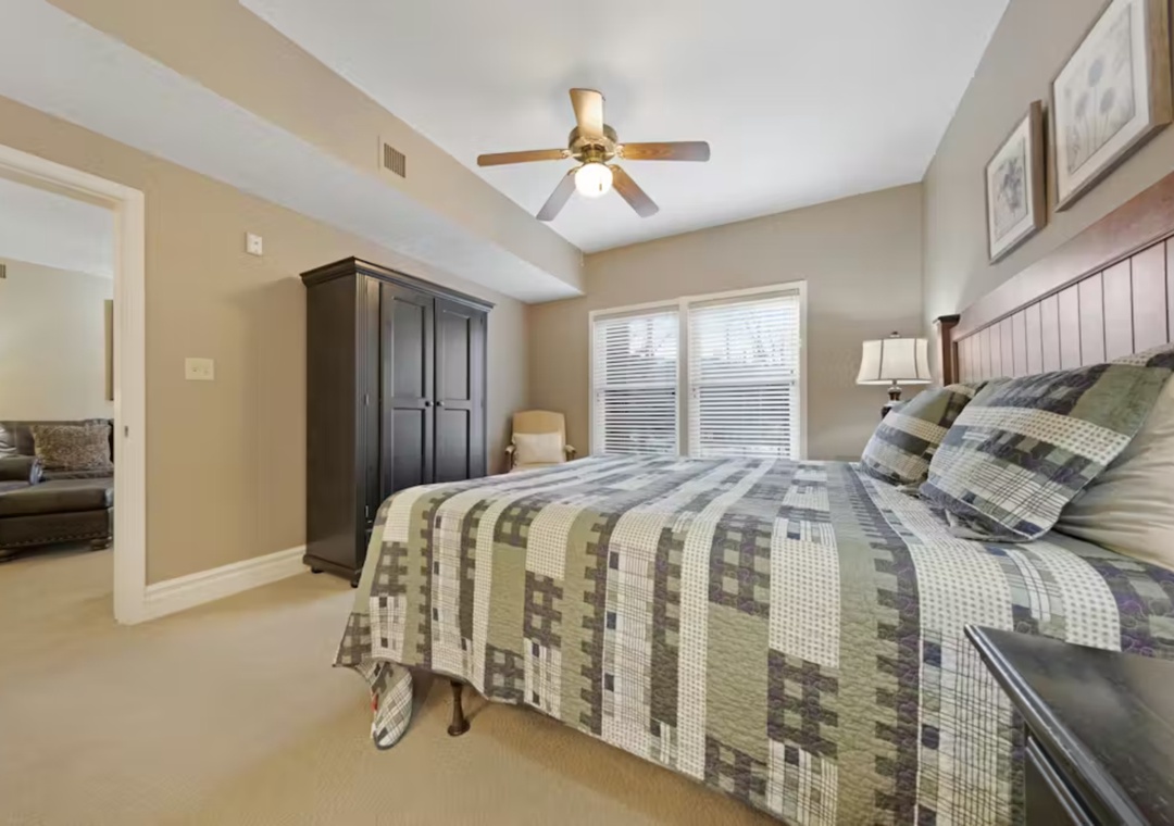 Drift into peaceful sleep in your spacious master suite, where soft quilted bedding and warm wood finishes create the perfect retreat.