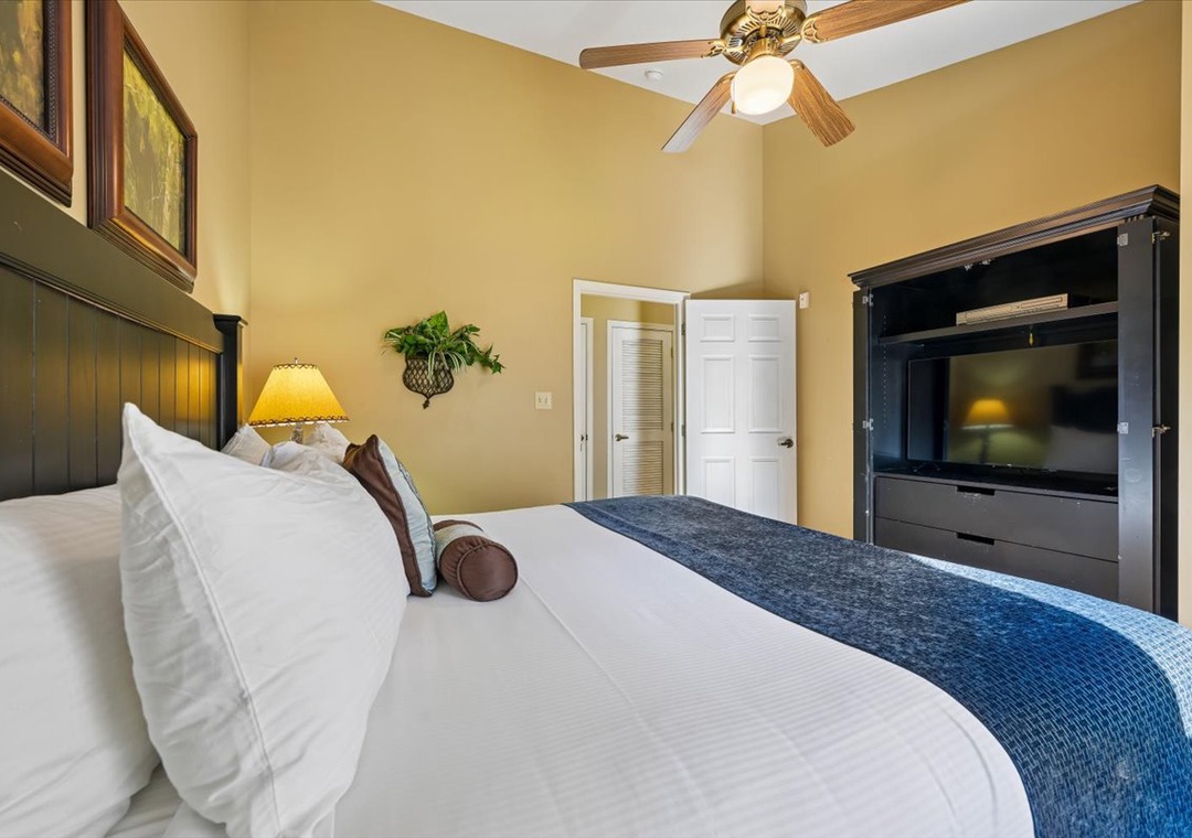 Sink into crisp linens and let the gentle ceiling fan breeze lull you to sleep in your elegant bedroom retreat.
