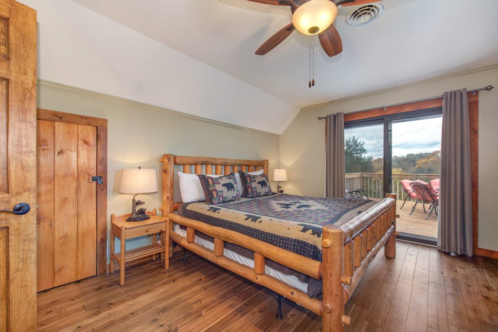 Drift off in your cozy log bed beneath the ceiling fan, then wake to stunning forest views just steps from your private deck.