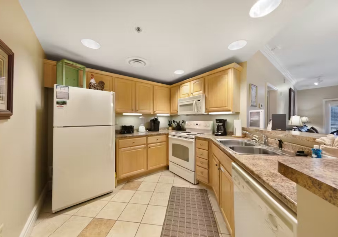 Your fully equipped kitchen features granite countertops, warm wood cabinets, and everything you need to create memorable meals during your stay.