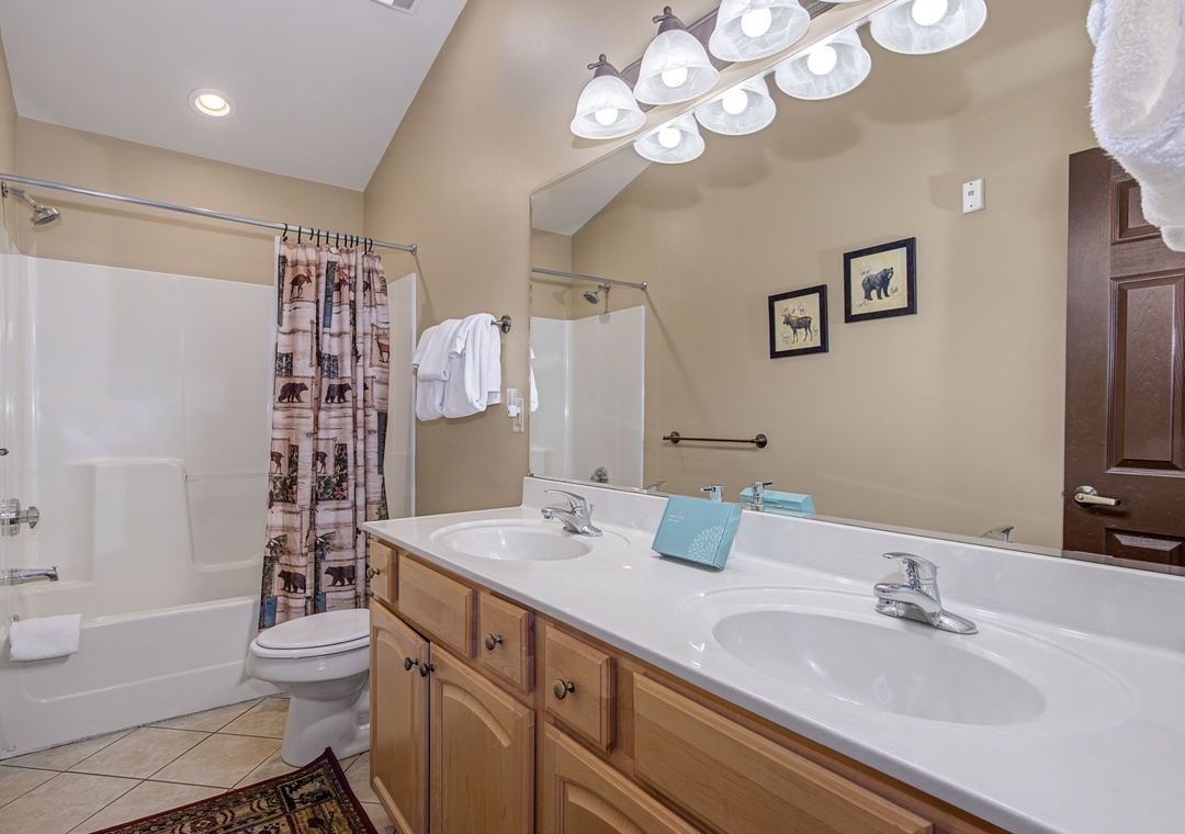 Refresh in your spacious bathroom with dual sinks, perfect for getting ready together, plus a relaxing bathtub for unwinding after adventures.