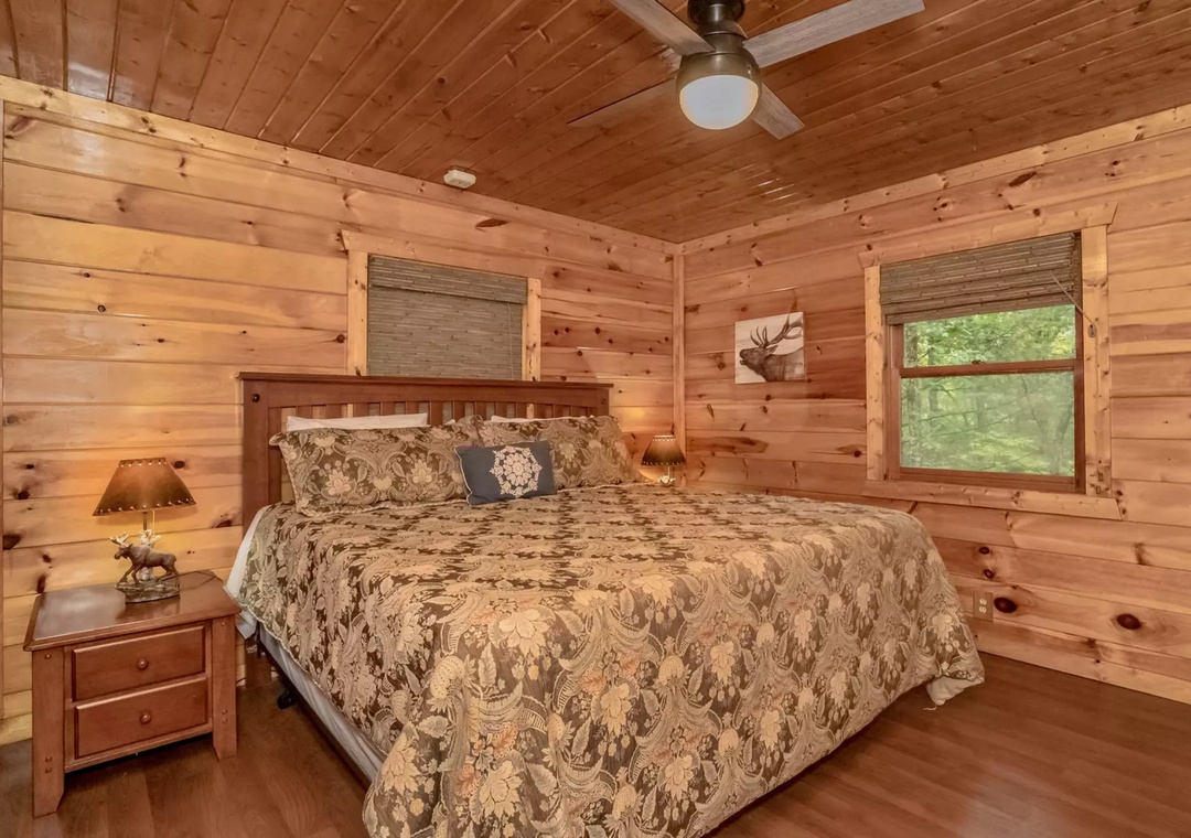 Drift off in this cozy log cabin bedroom where rustic charm meets comfort, surrounded by warm wood and natural light.