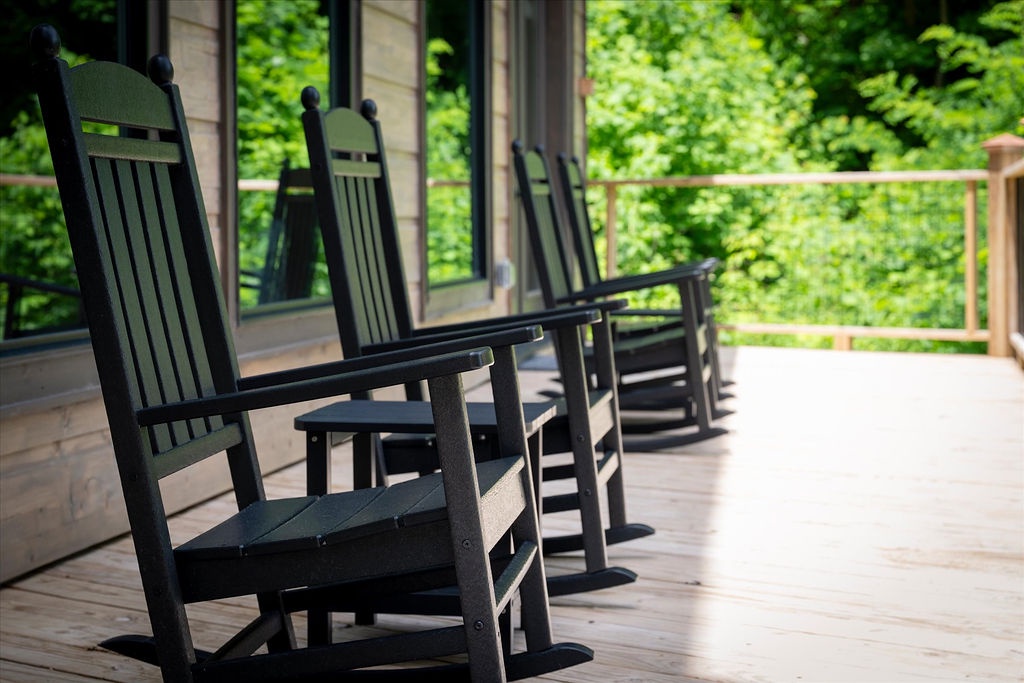 Relax in your rocking chair on this peaceful porch, surrounded by lush greenery and gentle forest breezes. A perfect spot to unwind and soak in nature's calming embrace.