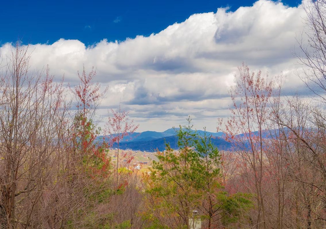 Scenic mountain landscape with rolling hills and autumn foliage visible from the surrounding area.