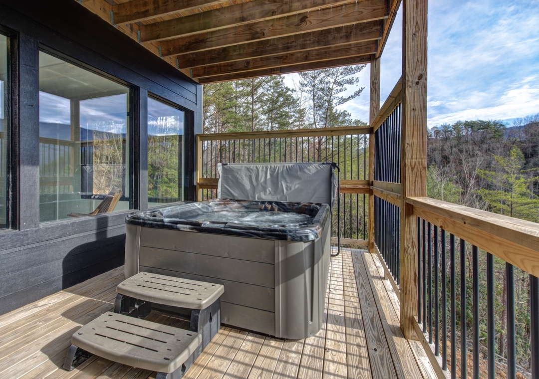Soak away your stress in your private hot tub while taking in breathtaking mountain views from this covered deck.