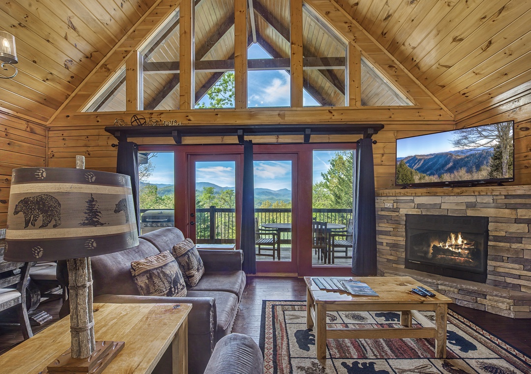 Unwind in your cozy mountain retreat with crackling fireplace, leather seating, and breathtaking views through floor-to-ceiling windows.