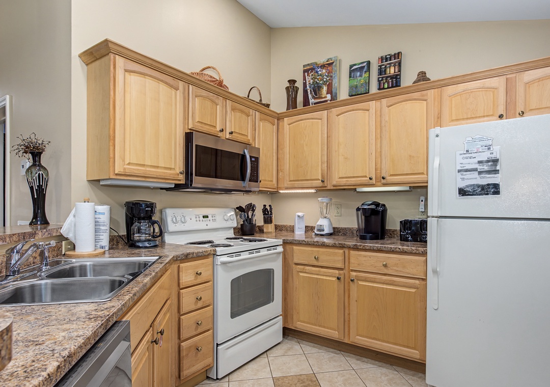Your fully equipped kitchen awaits with warm wood cabinets, granite counters, and everything you need to create memorable meals during your stay.