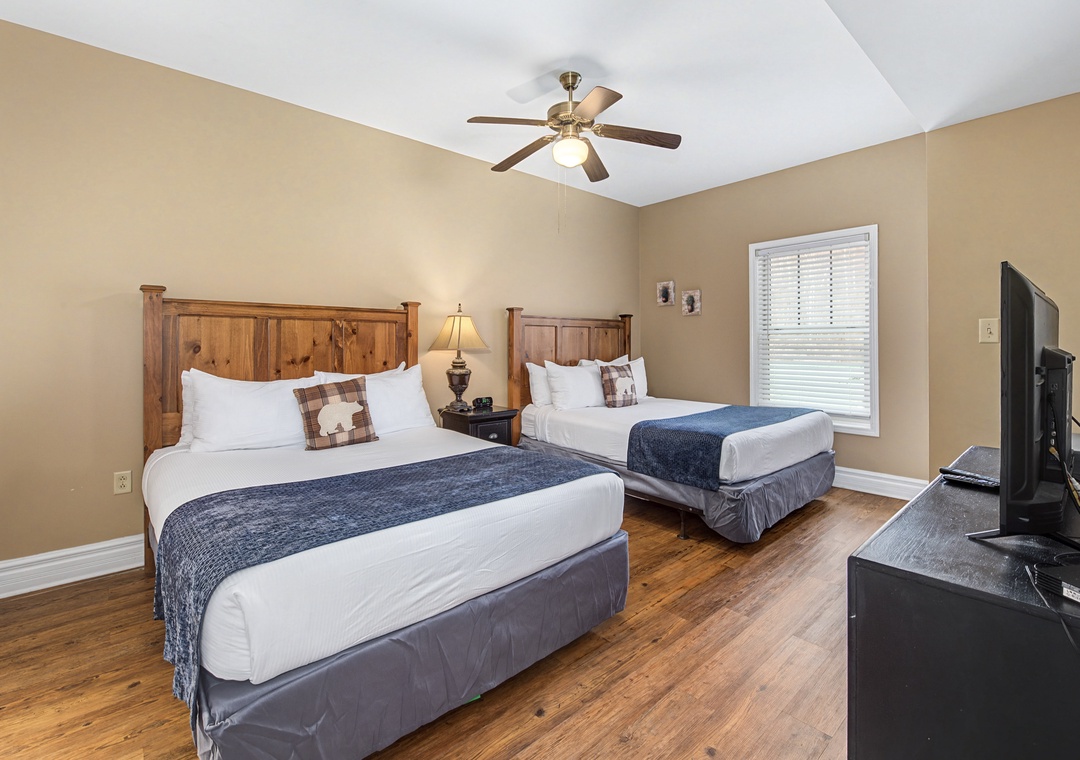 Your restful bedroom features two cozy beds with rustic wooden headboards, perfect for sharing your getaway with family or friends.