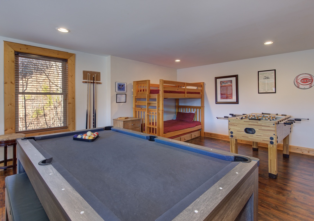 Challenge your family to pool and foosball in this fun-filled game room, featuring a cozy bunk bed for extra guests.