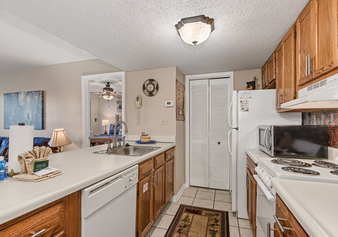 Cook your favorite meals in this fully-equipped kitchen with warm wood cabinets, modern appliances, and plenty of counter space for prep.