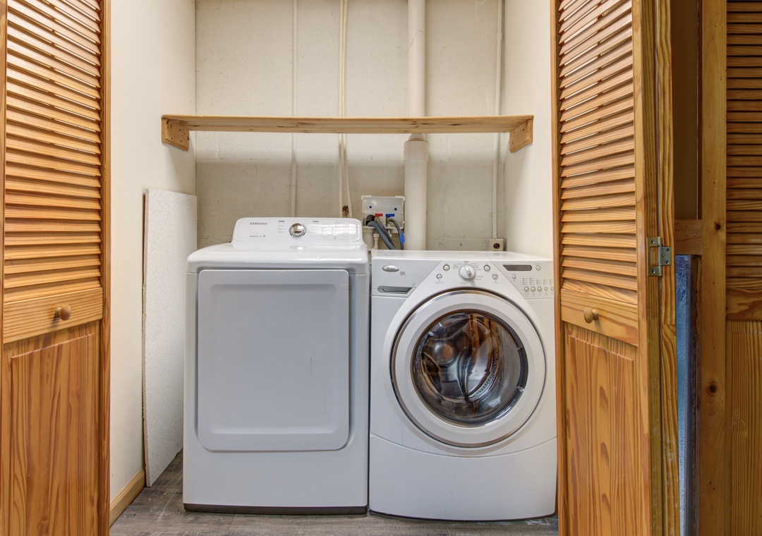 Keep your vacation wardrobe fresh with these convenient in-unit laundry facilities, tucked neatly behind charming wooden doors for easy access.