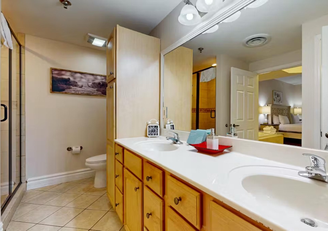 Spacious bathroom with dual vanities and thoughtful touches awaits your morning routine.