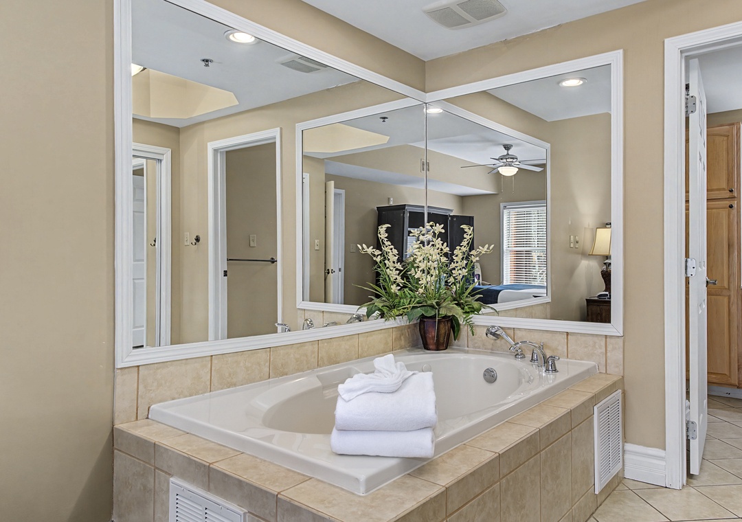 Sink into your private spa-like soaking tub, surrounded by elegant mirrors and soft lighting for ultimate relaxation.
