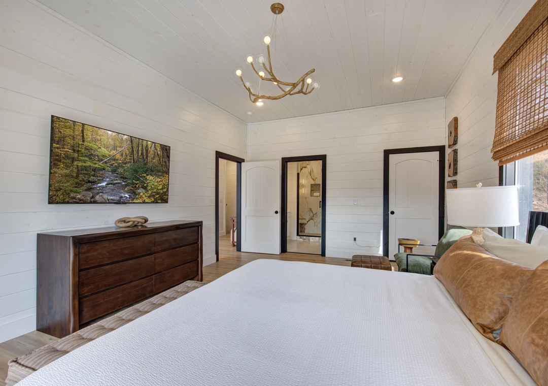 Drift into peaceful dreams in your serene bedroom, featuring crisp white linens and warm wood accents under elegant modern lighting.