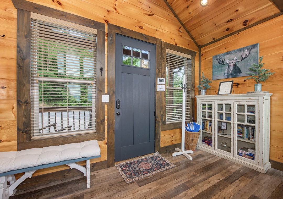 Step inside a warm cabin retreat featuring vaulted wood-planked ceilings and a cozy window bench perfect for morning coffee or getting lost in a good book.