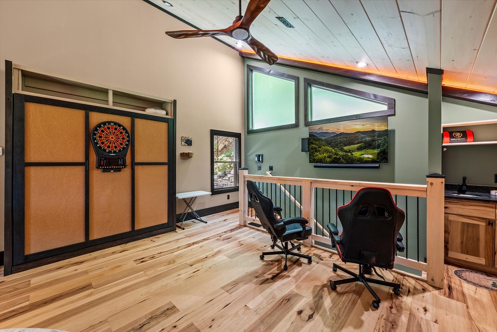 Your upstairs loft game room awaits with a dartboard, gaming chairs, and mountain views—perfect for family tournaments and friendly competition.
