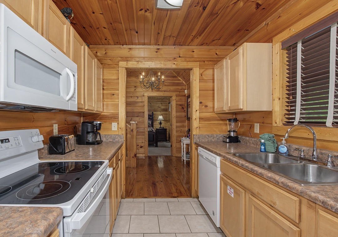 Step into your fully equipped kitchen, where warm wood tones and modern appliances make preparing meals a breeze. Everything you need for a comfortable stay is right here.