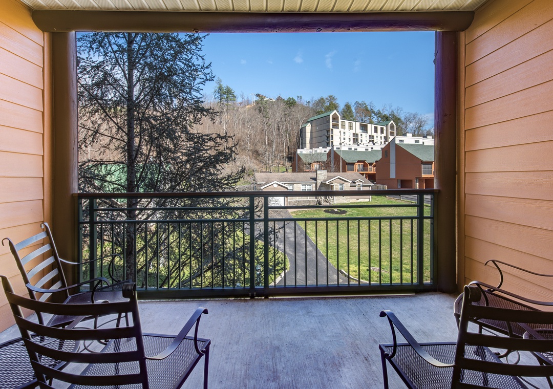 Your private balcony features comfortable seating where you can unwind while taking in peaceful views of the surrounding hillside.
