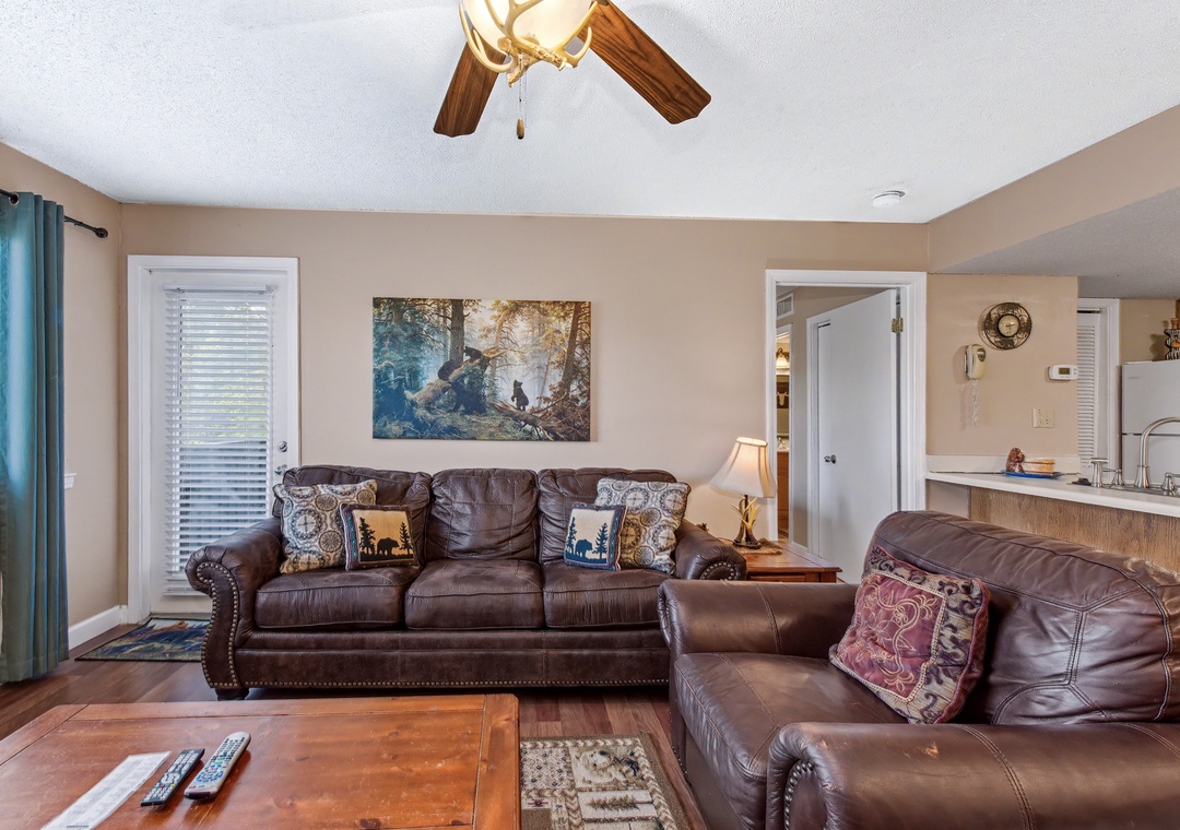 Unwind in your cozy living room with plush leather seating and warm lighting that invites relaxation after your adventures.