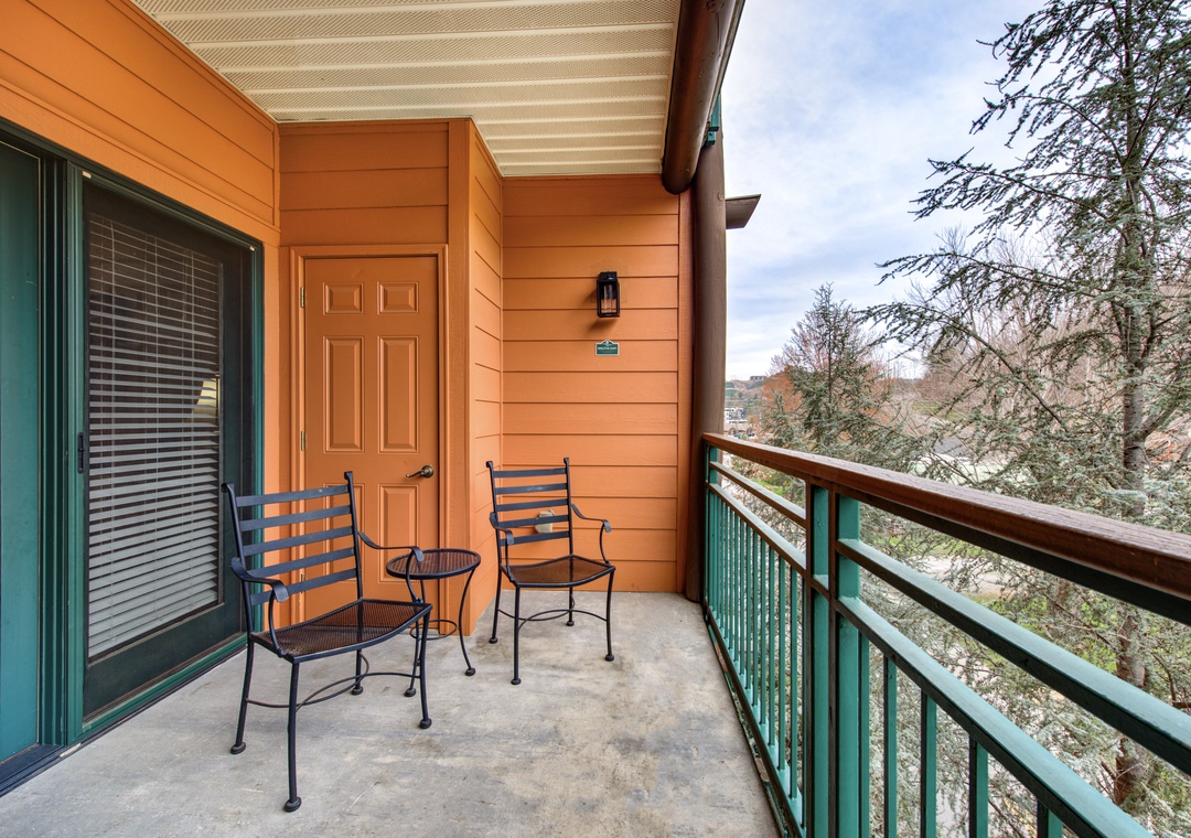 Step onto your private balcony and breathe in the fresh mountain air while enjoying peaceful forest views from your comfortable seating area.