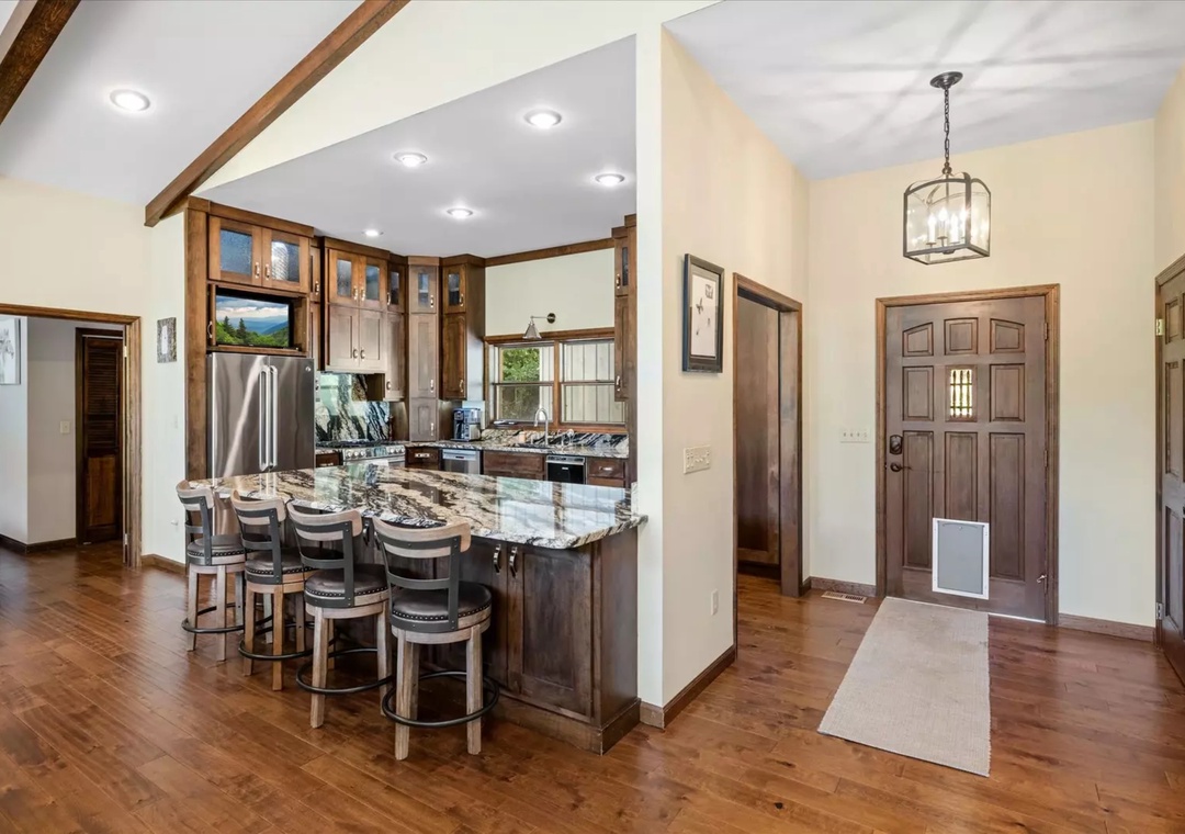 Your spacious kitchen features granite countertops, stainless steel appliances, and a breakfast bar where you can gather for morning coffee.