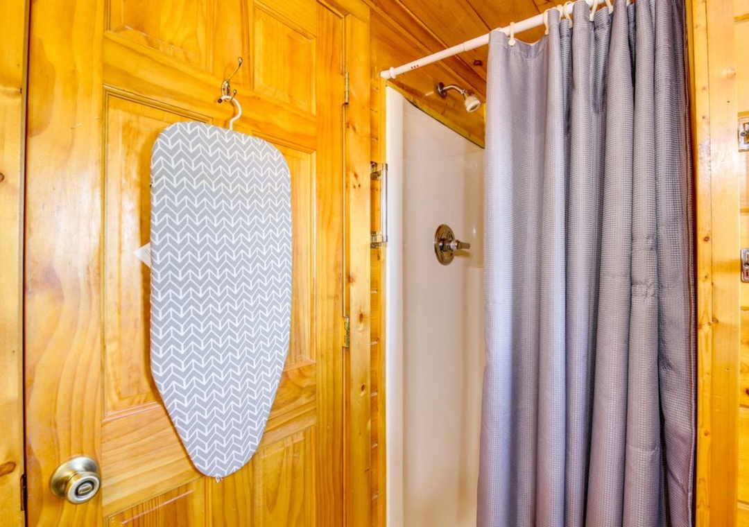 Your cozy cabin bathroom features warm wood accents and a spacious shower with modern fixtures for your comfort.