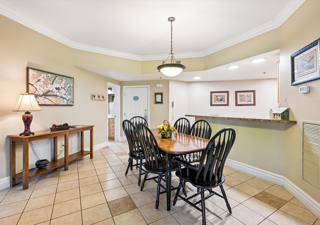 Gather around your elegant dining table where warm lighting and cheerful artwork create the perfect setting for memorable meals together.