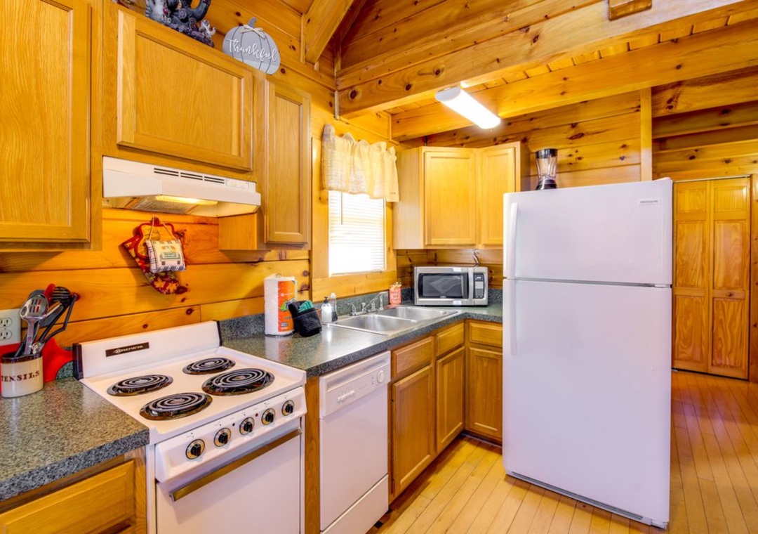 Your fully equipped log cabin kitchen invites you to cook hearty meals surrounded by warm wood and rustic charm.