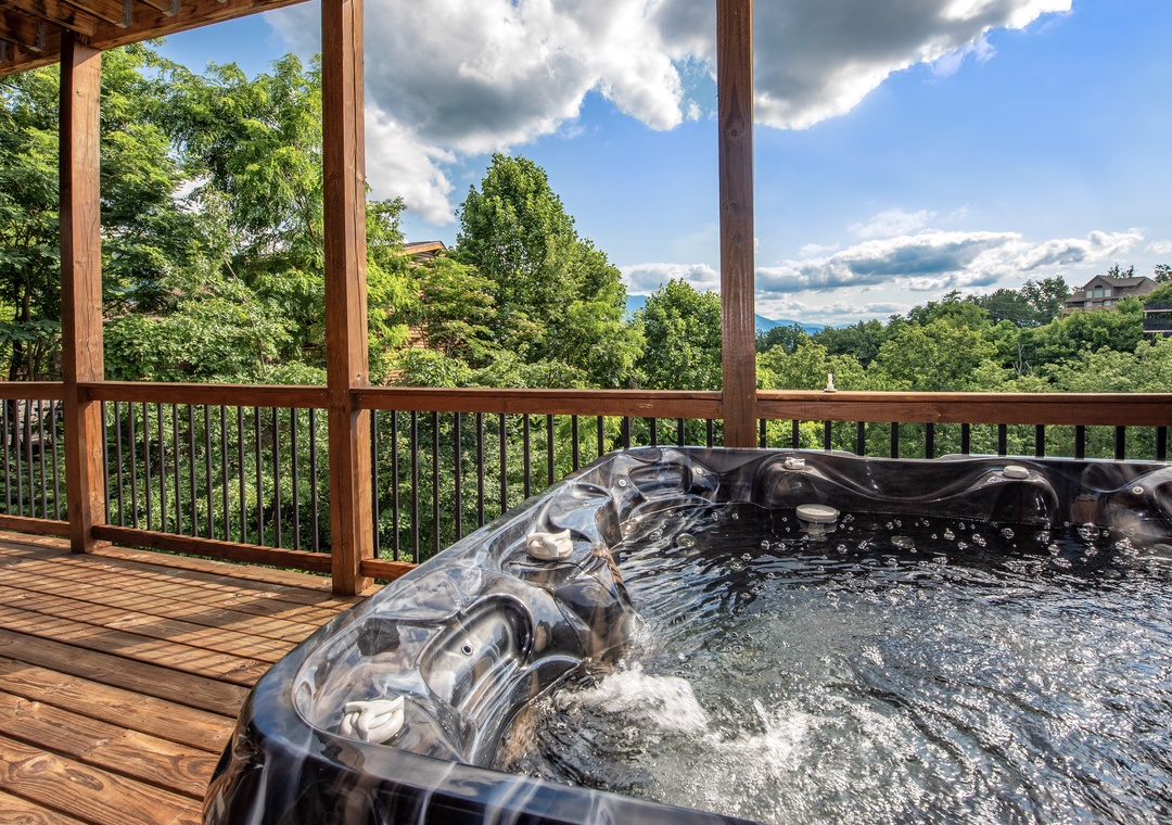 Soak in your private hot tub while gazing out at lush forest views and distant mountain peaks—a perfect spot to unwind after a day of adventure.