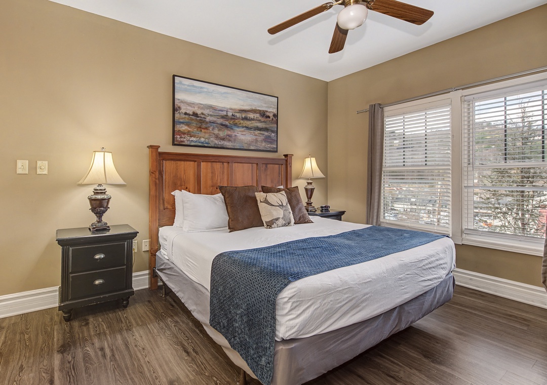 Sink into crisp linens and plush pillows in your cozy bedroom retreat, complete with warm lighting and peaceful views.