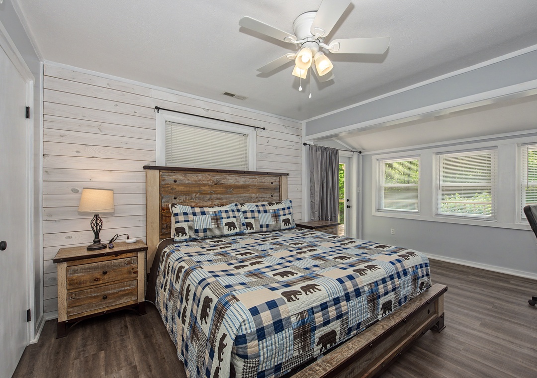 Rest peacefully in your rustic bedroom where reclaimed wood meets cozy comfort, complete with ceiling fan and natural light.