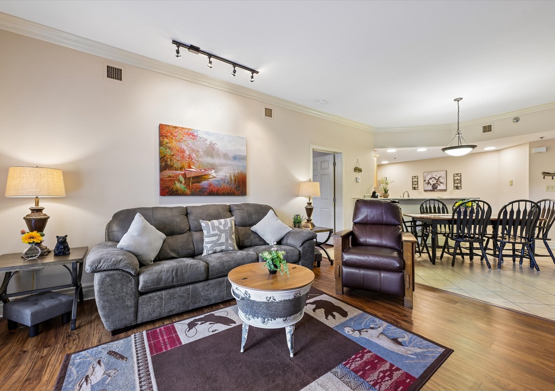 Unwind in your spacious open-concept living space, where comfortable seating and warm lighting invite you to relax after a day of exploring. The inviting dining area seats your whole group for shared meals and memories.
