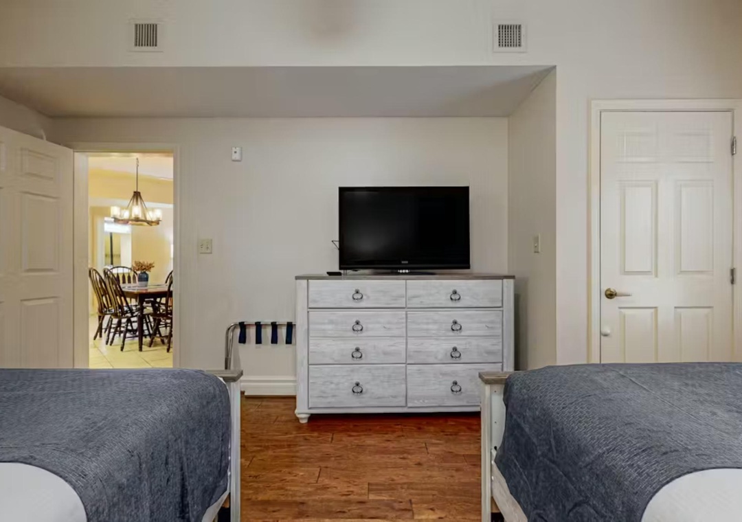 Relax in your cozy bedroom with two comfortable beds, perfect for sharing with family or friends after exploring nearby attractions.