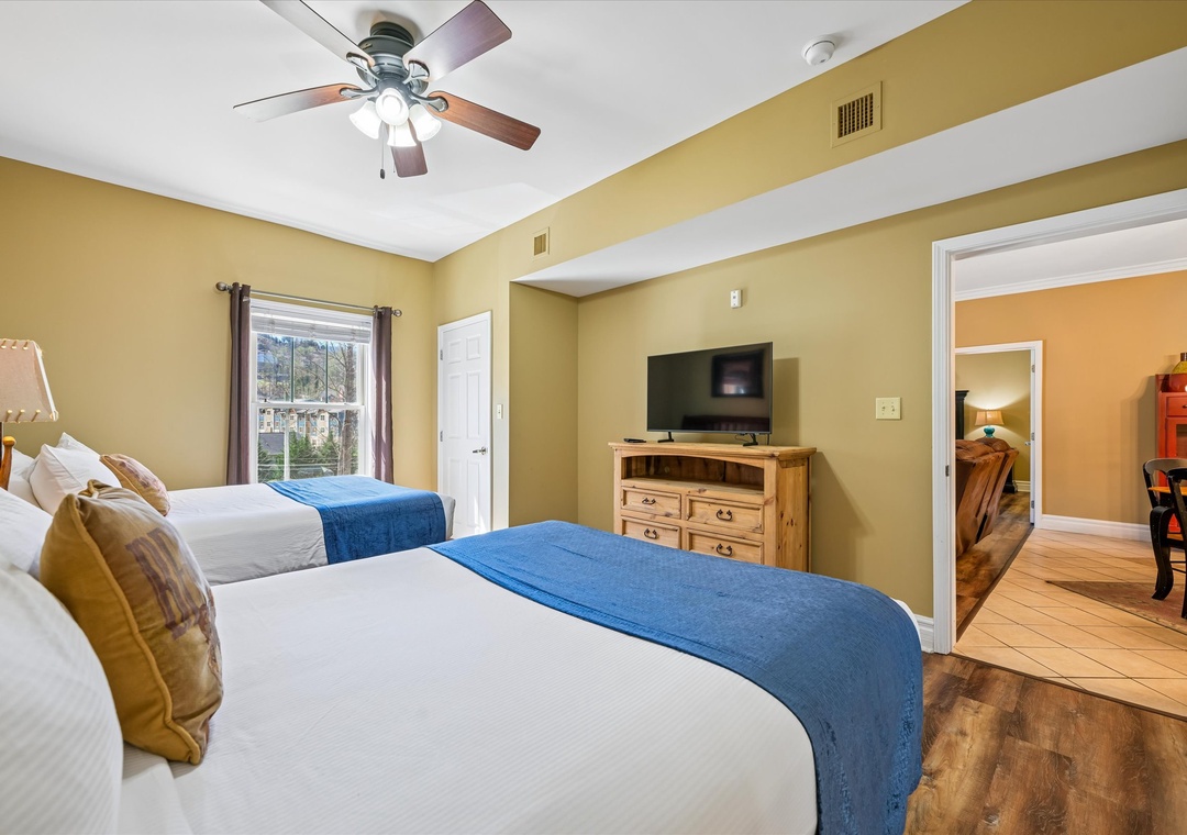 Your comfortable twin bedroom features two queen beds with crisp linens, a ceiling fan, and TV for relaxing after your adventures.