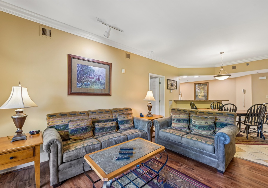 Settle into your cozy living space with plush sofas and warm lighting, perfectly connected to your dining area for comfortable gatherings.