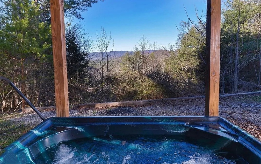 Soak in your private hot tub while mountain views frame your peaceful retreat.