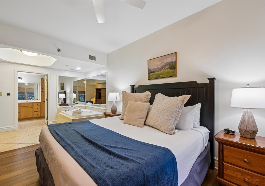 Unwind in your spacious suite with plush bedding, warm wood tones, and a relaxing spa tub just steps away.