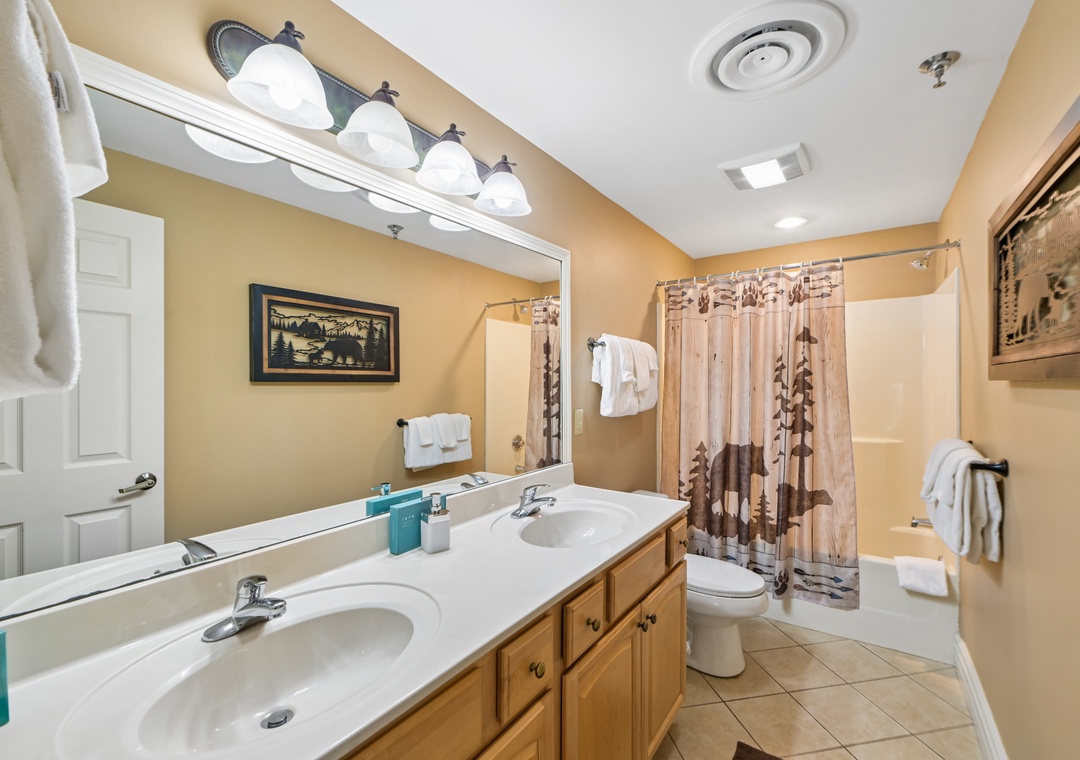 Your private bathroom features double sinks, fresh towels, and a relaxing tub-shower combo perfect for unwinding after your adventures.