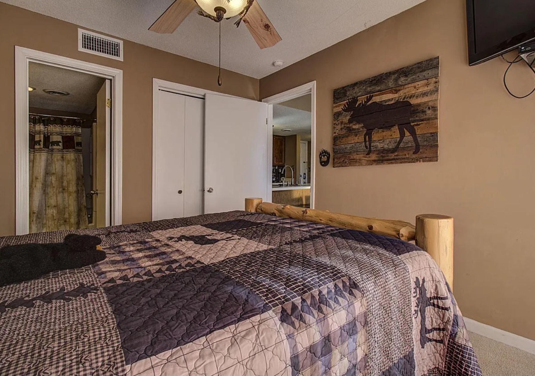 Your cozy bedroom features rustic charm with wildlife artwork and warm wood accents creating the perfect retreat for relaxation.